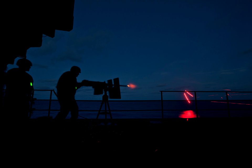 Flickr - Official U.S. Navy Imagery - Weapons Department Sailors on a sponson fire a .50-caliber machine gun.