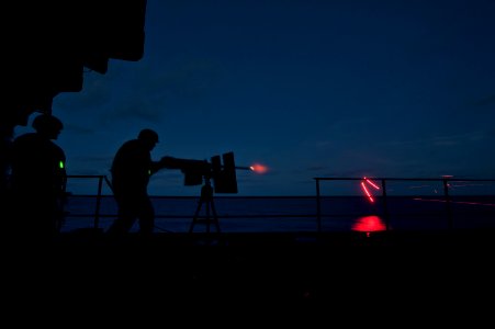 Flickr - Official U.S. Navy Imagery - Weapons Department Sailors on a sponson fire a .50-caliber machine gun.