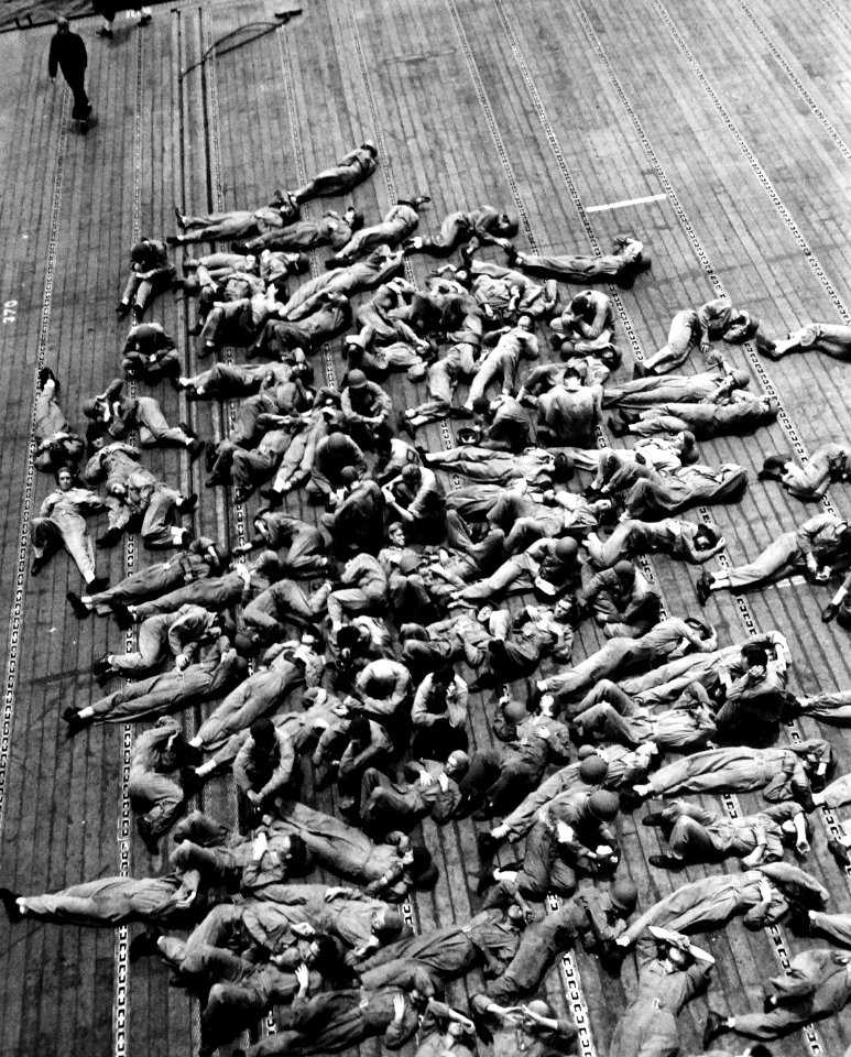 Flight deck crews resting aboard USS Enterprise (CV-6), in November 1942 (80-G-30540)