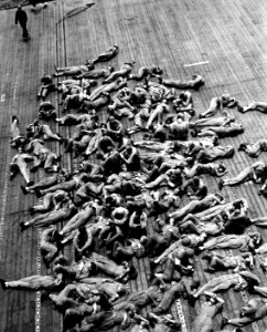 Flight deck crews resting aboard USS Enterprise (CV-6), in November 1942 (80-G-30540)