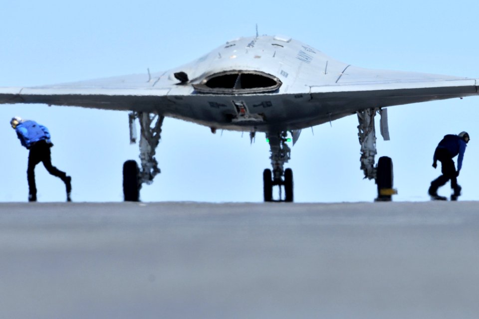 Flight deck crew prepare the X-47B for launch aboard CVN 77 (8738609025)
