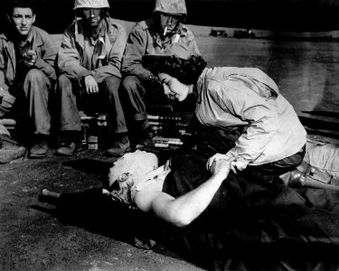 Flight nurse Jane Kendeigh caring for wounded soldier on Iwo Jima--1945