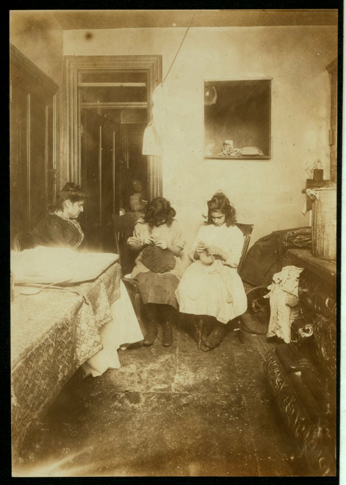 Florence Valentino, 12 yrs. old, and sister Jennie, working on crochet hats in dirty kitchen tenement, 3126 Jerome Ave. (Bronx). They make heavy hats, muffs, scarfs, slippers, etc. Jennie, LOC nclc.04114