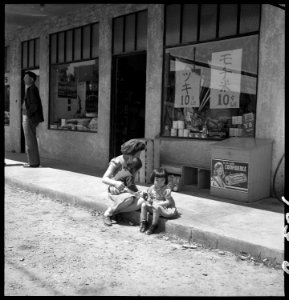 Florin, California. In front of grocery store owned by resident of Japanese descent, two days befor . . . - NARA - 537886 photo