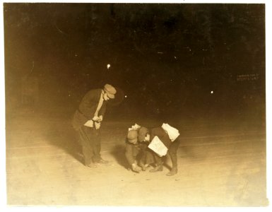 For Child Welfare Exhibit 1912-13.) Midnight, Nov. 23, 1912. Providence, R.I. Newsboys shooting craps near Post Office. Been playing here at craps for an hour. Flash-light photo LOC cph.3a48752