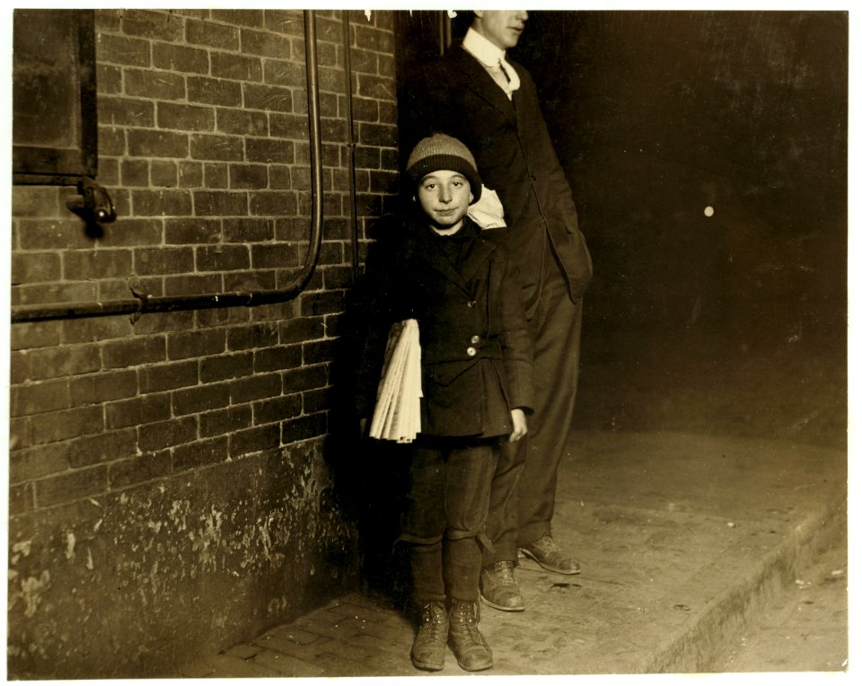 For Child Welfare Exhibit 1912-13.) Nearly midnight, Ten year old newsboy selling in and around this saloon near Market Square, Providence, R.I. Flash-light photo LOC nclc.03809