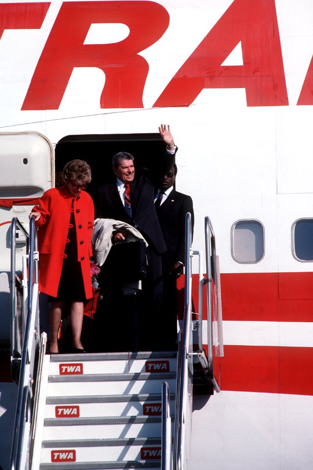 Former President Ronald Reagan and his wife, Nancy, disembark a Boeing 747 commercial aircraft upon their arrival in Tokyo