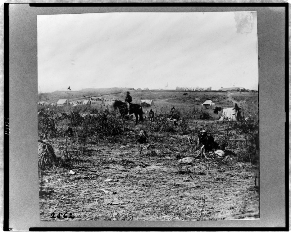 Fort Burnham, formerly Confederate Fort Harrison, James River, Virginia, with man on horseback and tents in background LCCN98503561