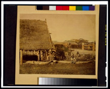 Four Ainu men with two boats, by thatched roof building, on the island of Hokkiado, Japan LCCN98511948