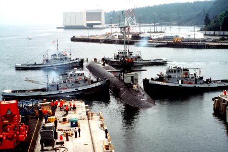 Four Natick class harbor tugs guide USS Ohio (SSBN-726) out of drydock