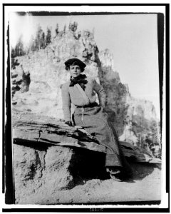 Frances Benjamin Johnston, full-length portrait, seated on rock in Yellowstone National Park, facing front LCCN98506430