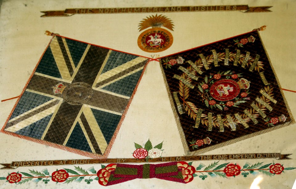 Framed Union Flag and Battle Flag presented to Northumberland Fusiliers.