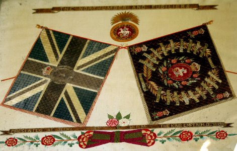 Framed Union Flag and Battle Flag presented to Northumberland Fusiliers.