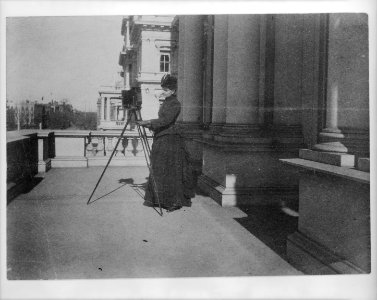 Frances Benjamin Johnston with camera on balcony of State, War and Navy Building (now the Dwight D. Eisenhower Executive Office Building), Washington, D.C., 1888 LCCN96510212