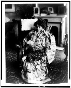 Frances Alda, full-length portrait, seated, facing left, wearing kimono, holding dog LCCN91783838 photo