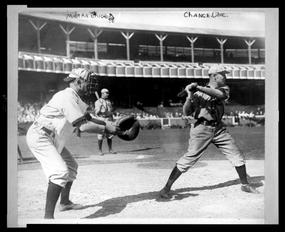 Frank Chance, Chicago NL baseball player, standing at home plate, with bat in hand about to swing, the catcher, Pat Moran, Chicago NL, stands to the left ready to receive the pitched ball LCCN2003689080