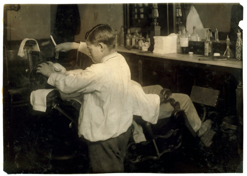 Frank De Natale, a 12-year old barber. Lathers and shaves customers in father's shop, 416 Hanover Street, after school and Saturday. LOC nclc.05619
