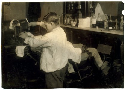 Frank De Natale, a 12-year old barber. Lathers and shaves customers in father's shop, 416 Hanover Street, after school and Saturday. LOC nclc.05619