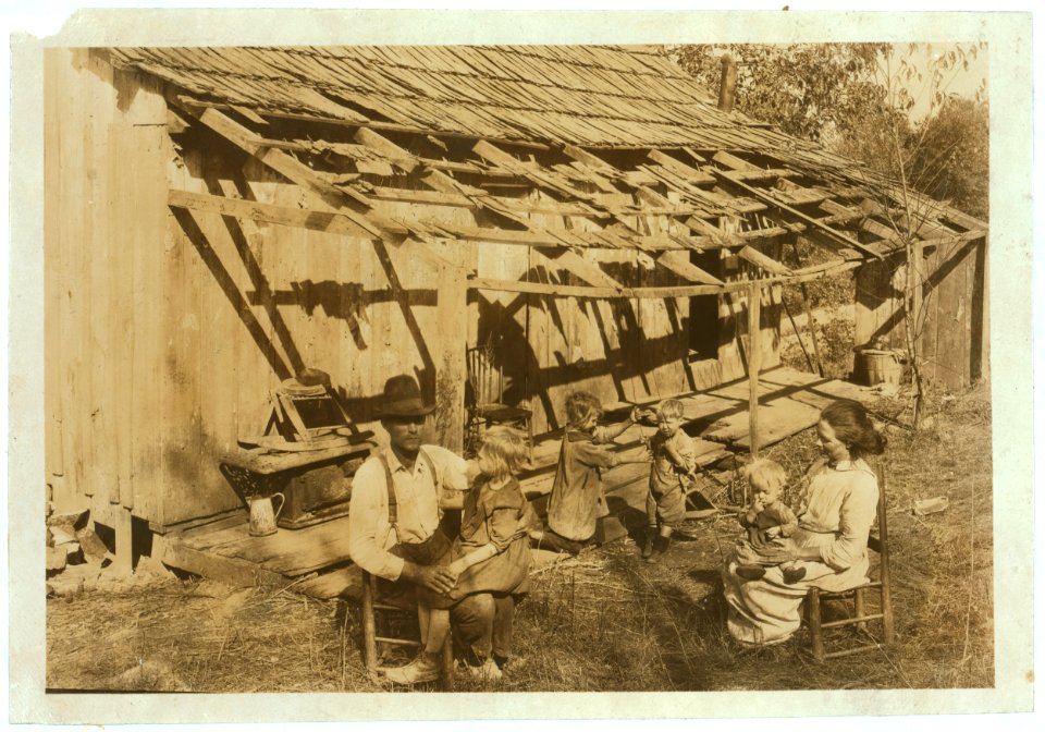 Frank Burditt and family. They rent this dilapidated shack and are trying to make a living off the meagre land near by. LOC nclc.04423