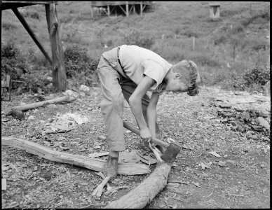 Franklin D. Sergent chopping kindling. P V & K Coal Company, Clover Gap Mine, Lejunior, Harlan County, Kentucky. - NARA - 541308