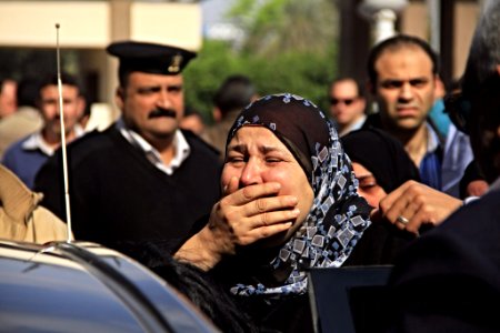 Grieving friends and relatives gather outside the Agouza Police Hosptial after a series of explosions at Cairo University left many dead or wounded - Cairo 2-Apr-2014