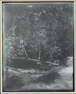 Group crossing footbridge with cameras LCCN2001697162