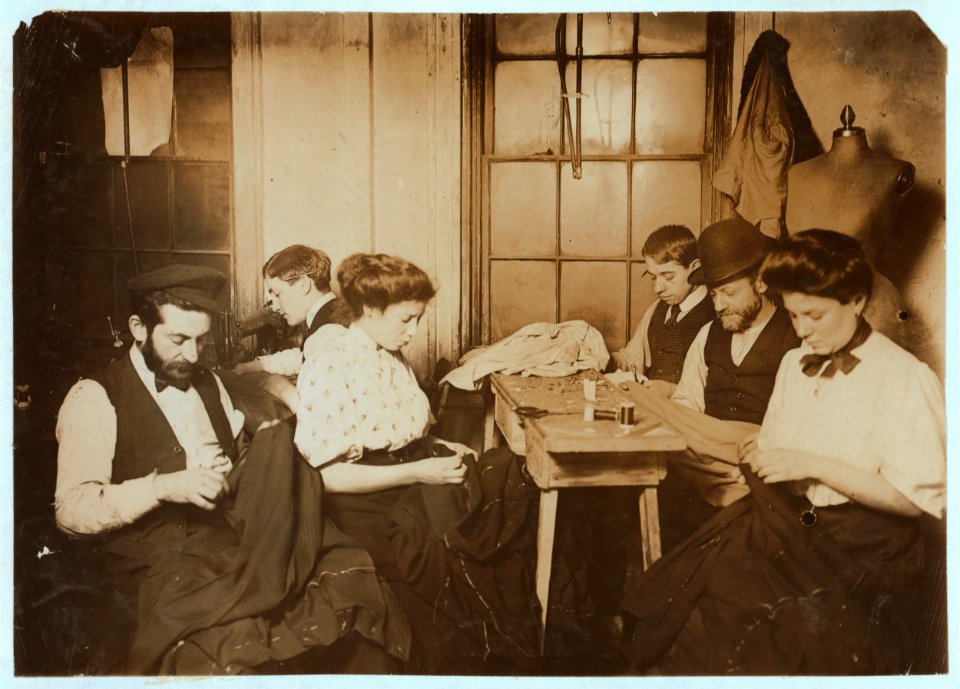 Group in Sweatshop. Mr. Schneider, 87 Ridge Street Shop located in the second inner court. Group just finishing week's work. Witness Mrs. Lillian Hosford. LOC cph.3a21184