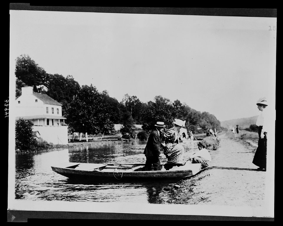 Group disembarking from a rowboat along the Chesapeake and Ohio Canal near the Abner Cloud House at Fletcher's Cove, Georgetown, D.C. LCCN2008678787