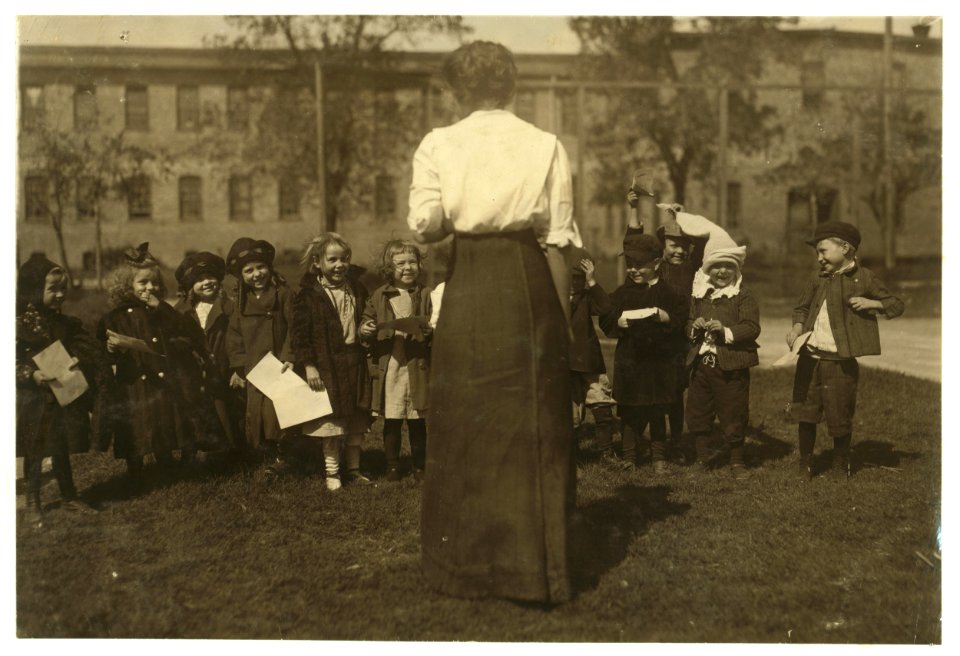Group of children in the kindergarten school composed of the cotton mill people. Even during the play the mill is ever in the background. Dallas Cotton Mill. LOC nclc.02856