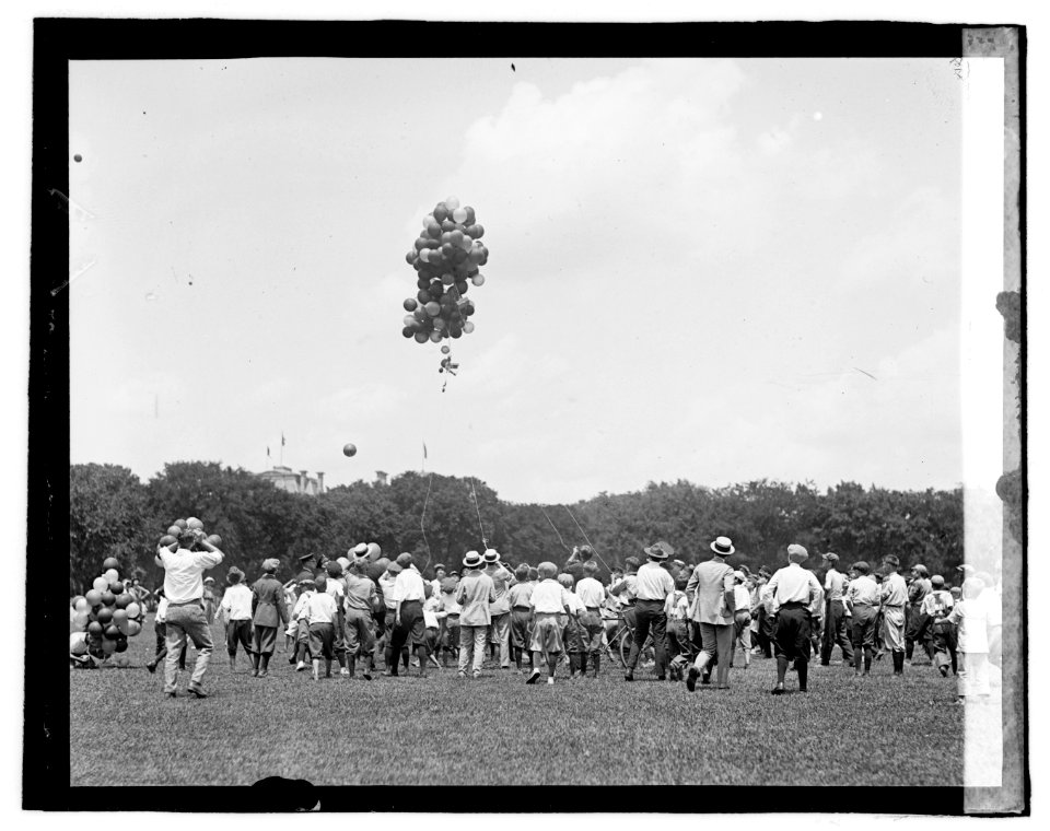 Group of boys watching bunch of balloons ascending LOC npcc.06696