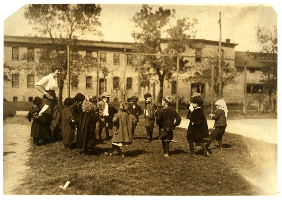 Group of children in the kindergarten school composed of the cotton mill people. Even during the play the mill is ever in the back ground. Dallas Cotton Mill. LOC nclc.02855