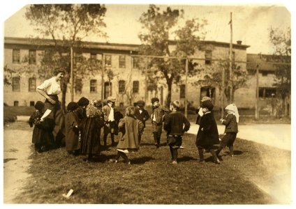 Group of children in the kindergarten school composed of the cotton mill people. Even during the play the mill is ever in the back ground. Dallas Cotton Mill. LOC nclc.02855