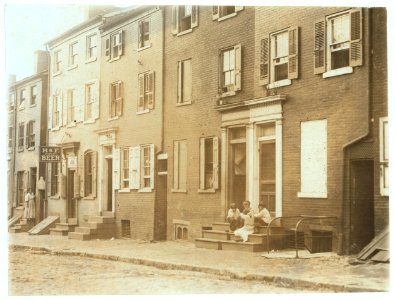 Group of children playing on the stoop of a house next to 229 Tatnall St., a reputed house of prostitution. Investigator, Edward F. Brown. LOC nclc.04667
