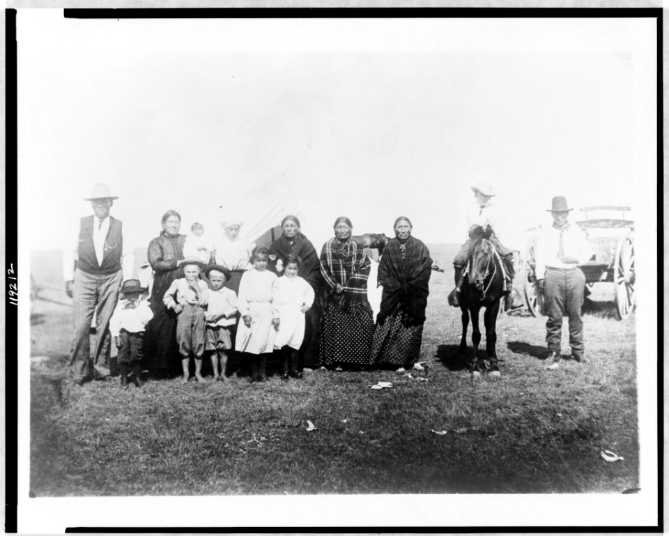 Group of Kickapoo Indians, standing outside tent, dressed in Euro-American clothing LCCN97512086