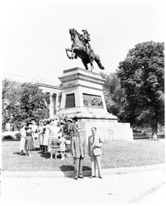 Group of people gathered in front of an equestrian statue of Jose de San Martin, Washington, DC. - NARA - 199871