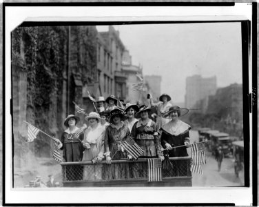 Group of women standing on top of vehicle waving flags, New York City LCCN97511965 photo