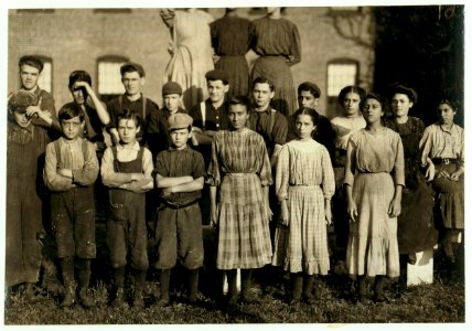 Group of workers going to work at 6-45 A.M. In Spring Village Mill. In this group are Mamie La Barge, Elizabeth and Lumina Demarais, Als de Gauthier, Erena La Prise (See previous labels for LOC nclc.02307