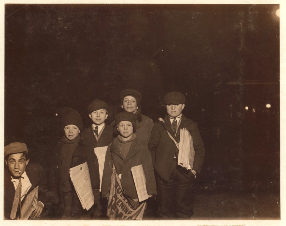 Group on Court St., selling around the 'Shea' Theater, 8 P.M. Boy in center - Vito Bucheto, 10 years old, 162 Court St. Behind him to left- Tony Gregoria 12 years old, 69 Front St.,. LOC nclc.03403