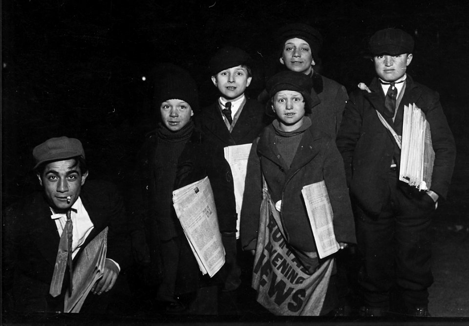 Group on Court St. selling around the Shea Theatre, 8 P.M. Boy in center, Vito Bucheto, 10 years old. Behind him to... - NARA - 523275 (cropped)