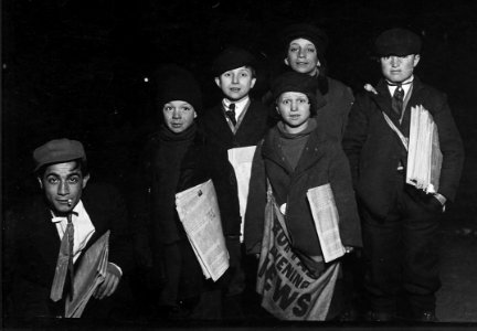Group on Court St. selling around the Shea Theatre, 8 P.M. Boy in center, Vito Bucheto, 10 years old. Behind him to... - NARA - 523275 (cropped)