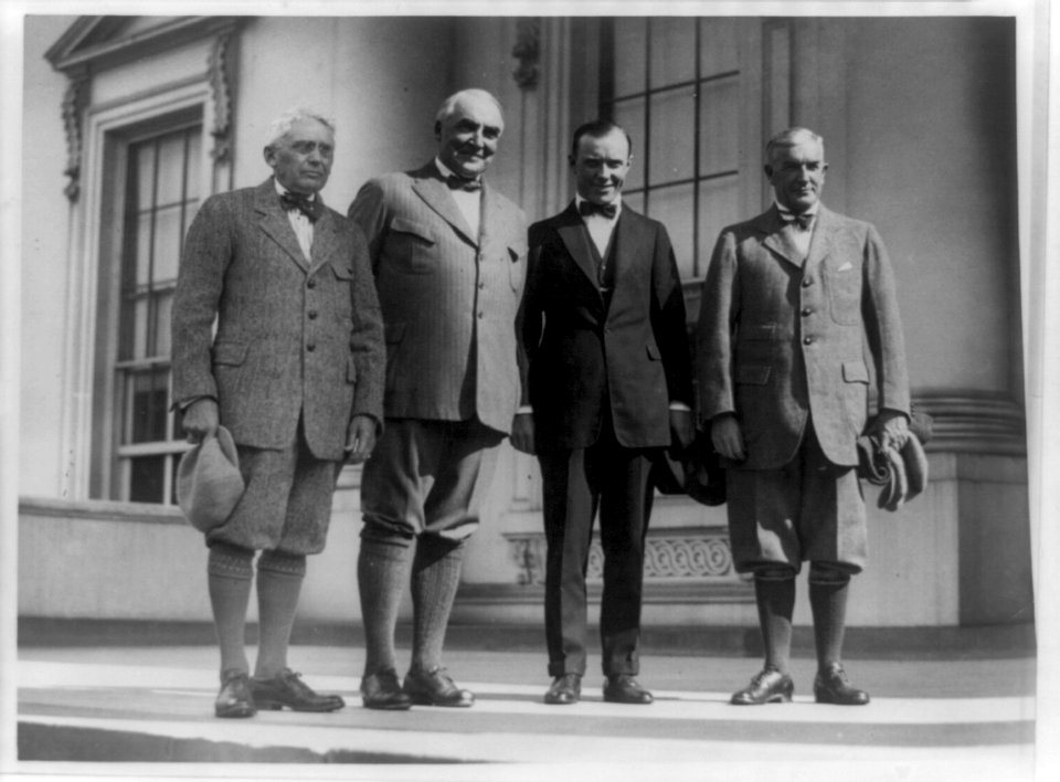 Group portrait of, standing left to right- Frank Billings Kellogg, Warren G. Harding, Chick Evans (a golfer), and Henry Prather Fletcher; three are wearing knickers LCCN89709894