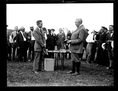 Group with Warren G. Harding holding trophy LCCN2016891456