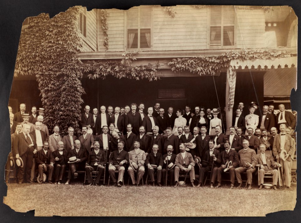 Group portrait of Theodore Roosevelt, seated in front row, left center, with group of men and women LCCN2013651092