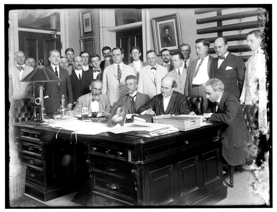 Group- includes William Jennings Bryan (at desk, 2nd from right); and Josephus Daniels, middle of 2nd row LOC hec.13466