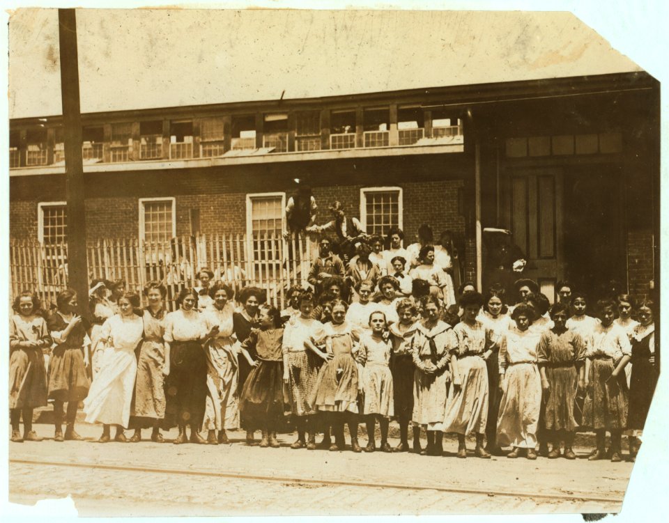 Groups of girls workers at the gate of the American Tobacco Co., Wilmington, Delaware, noon period, May 24, 1910. Young girls obviously under 14 years of age, who work about 10 hours a day LOC nclc.04672