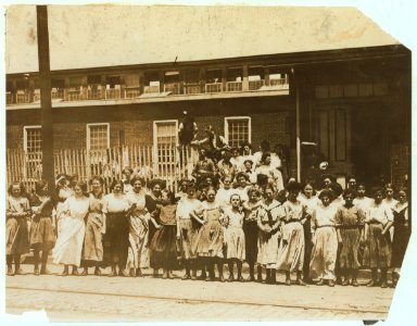 Groups of girls workers at the gate of the American Tobacco Co., Wilmington, Delaware, noon period, May 24, 1910. Young girls obviously under 14 years of age, who work about 10 hours a day LOC nclc.04672