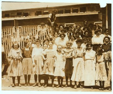 Groups of girls workers at the gate of the American Tobacco Co., Wilmington, Delaware, noon period, May 24, 1910. Young girls obviously under 14 years of age, who work about 10 hours a day LOC nclc.04673