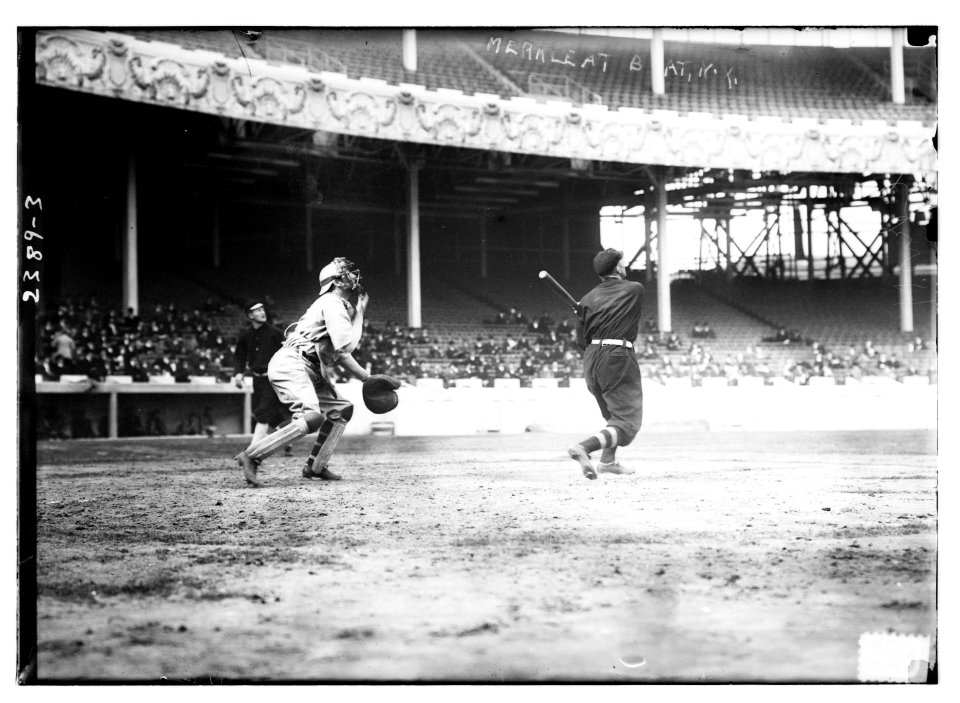 Fred Merkle (New York NL) at bat, Red Murray (New York NL) walking in background, and unidentified catcher at the Polo Grounds, NY, 1911 World Series (baseball) LCCN2014690307