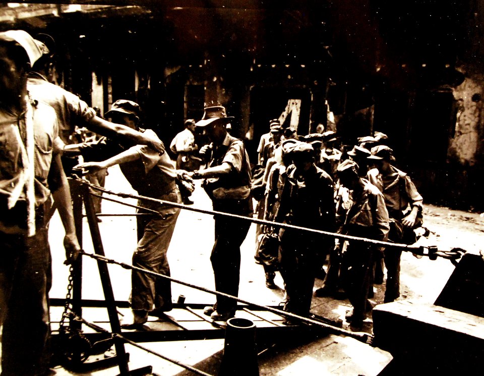 Freed British and Australian prisoners of war go aboard USS Thomas E. Gary (DE 326) after liberation by U.S. Marines on Formosa