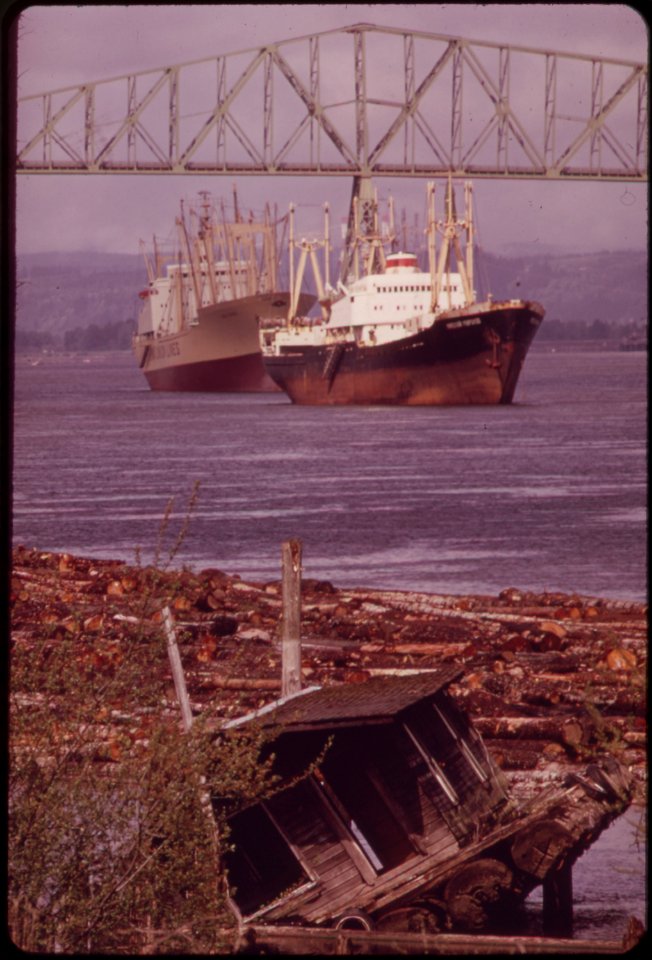 Freighters-coming-into-dock-at-rainier-oregon-on-the-columbia-river-old-lumbermans-shack-uprooted-by-wind-and-weather-seems-ready-to-slide-into-log-boom-041973 4272330126 o